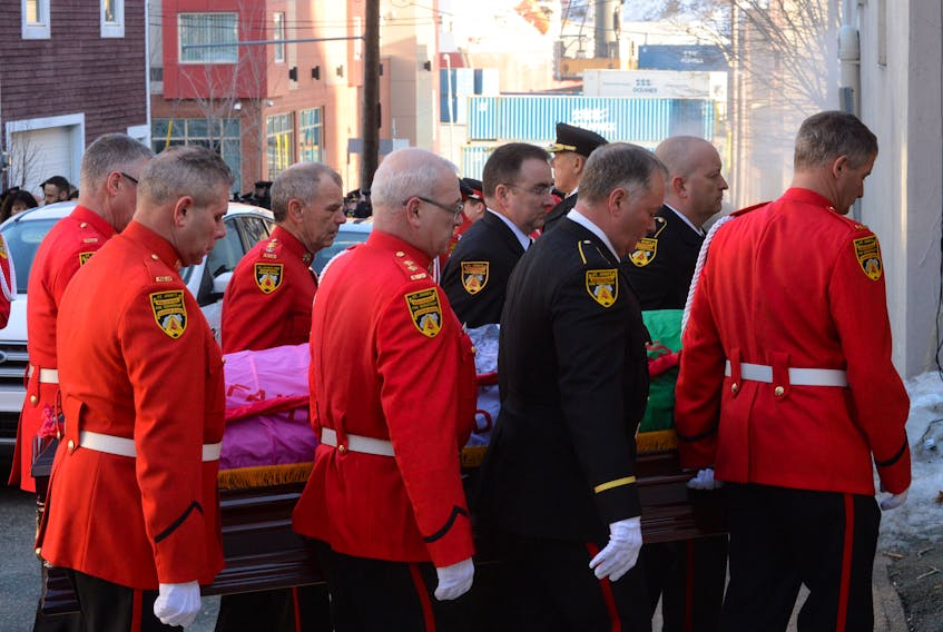 SJRFD firefighters and pallbearers (from left) Fire Insp. Gary Power, F/Lieut. Gerard Hayes, D/Chief Don Byrne (retired), F/Capt. Steve Morris, F/Lieut. Dean Foley, F/Lieut. Dave Boland, F/F Craig Kennedy and F/F Kenny Roche carry the casket Friday during F/Lieut. Todd Walsh’s funeral at George Street United Church in St. John’s.