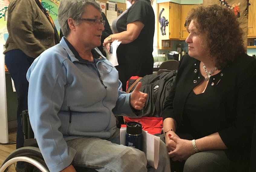 Joanne MacDonald (left) speaks with Service NL Minister Sherry Gambin-Walsh about new accessibility regulations following the announcement at the Empower building on Escasoni Place in St. John’s Monday.