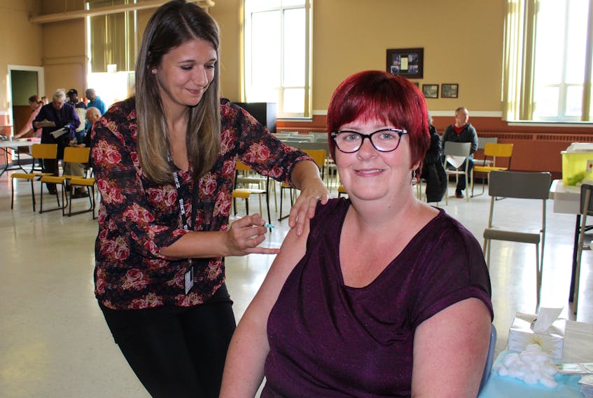 Lori Hunt, a clerk/typist at the Eastern Health office in Mount Pearl, gets a flu shot from Eastern Health registered nurse Krista Ash on Tuesday at St. Pius X Parish Hall in St. John’s.