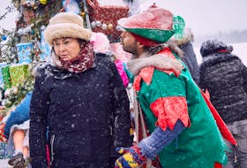Shaun Majumder, as gravedigger Cyril Pippy, puckers up for a kiss from Mamie Lou Furey (Mary Walsh) in a scene from “Christmas Fury,” airing on CBC-TV Sunday night.
