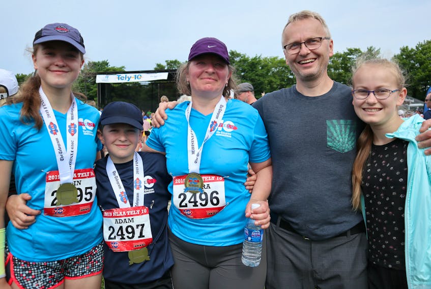 (From right) Zora Maskova and her dad Vlastimil Masek were cheering for (from left) Elin, Adam and her mother, Jindra, at the Tely 10 finish line. —