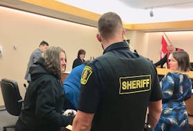 Anne Kelly (left) prepares to be handcuffed and led out of the courtroom in provincial court in St. John’s Thursday after she was sentenced to four years in jail for armed robbery at a Shoppers Drug Mart in Mount Pearl two years ago. Kelly’s lawyer, Karen Reiner, and Judge Jim Walsh are seen on the right, and Crown prosecutor Richard Deveau on the left.