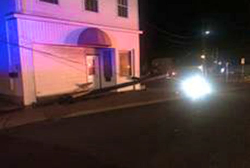 A car struck a power pole on Jury Street causing it to break and damage a nearby building.