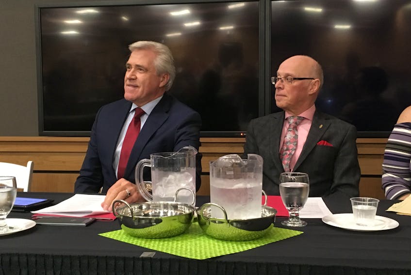 Premier Dwight Ball and Health Minister John Haggie speak to reporters Thursday about the site of the new Waterford Hospital.