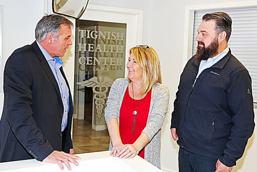 Health and Wellness Minister Robert Mitchell speaks with Tignish Health Centre manager Wendy Arsenault and MLA Hal Perry about the programs and services offered at the Centre during a recent visit.  ©THE GUARDIAN