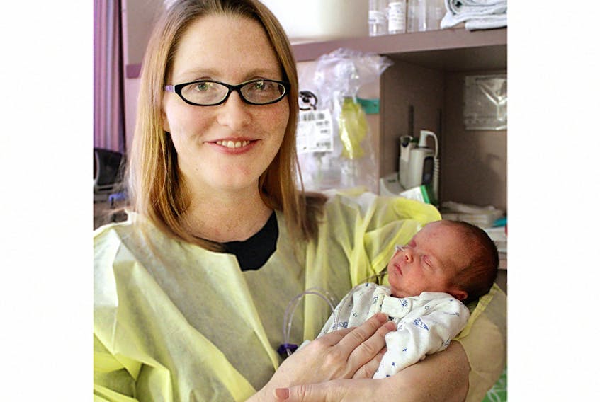 Baby Tully Hughes, shown with his mom, Dianne Mallard, is waiting to go home from the Queen Elizabeth Hospital in this March 2 photo.  ©THE GUARDIAN