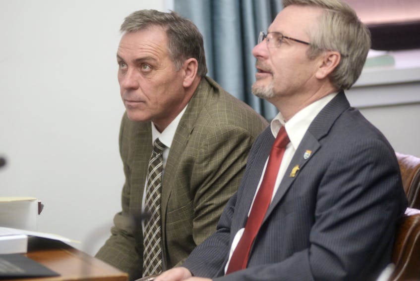 Health Minister Robert Mitchell, left, shown with Fisheries and Agriculture Minister Robert Henderson, says people have to be residents of P.E.I. for 183 days in order to get a health card. He was responding to questions in the legislature Wednesday by Opposition health critic Sidney MacEwen, who wanted to know if immigrants who used the motel address involved in a current immigration investigation have P.E.I. health cards.