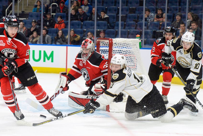 Charlottetown Islanders forward Nikita Alexandrov, kneeling, tries to control a wraparound chance on Quebec Remparts goaltender Antoine Samuel while being defended by Remparts centre Jesse Sutton in Quebec Major Junior Hockey League playoff action in Quebec City, Que. Behind the net is the Isles Brett Budgell (#10) and Quebec’s Benjamin Gagne (#9). Quebec won 5-2.
Photo special to the Guardian by Jean-Marie Villeneuve/Le Soliel