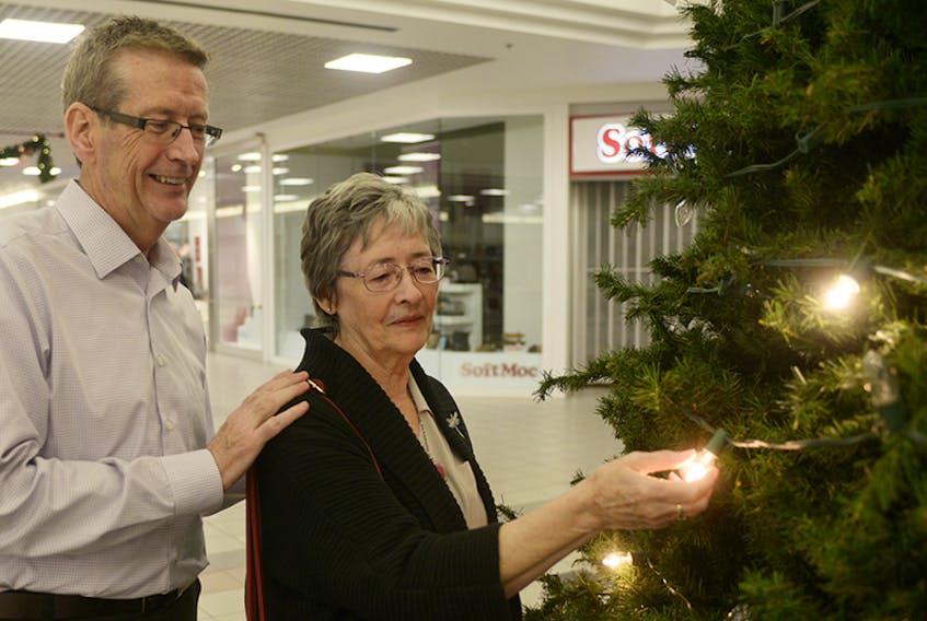 Siblings Kerry Lambe, left, and Janet Pickard shine a light in memory of their mother Ruth Lambe during the opening ceremony for Hospice P.E.I.’s 23rd annual Let Their Light Shine campaign at Charlottetown Mall. The campaign allows Islanders to make a donation to Hospice P.E.I., write their loved one’s name on a card and shine a light in memory of them.  ©THE GUARDIAN