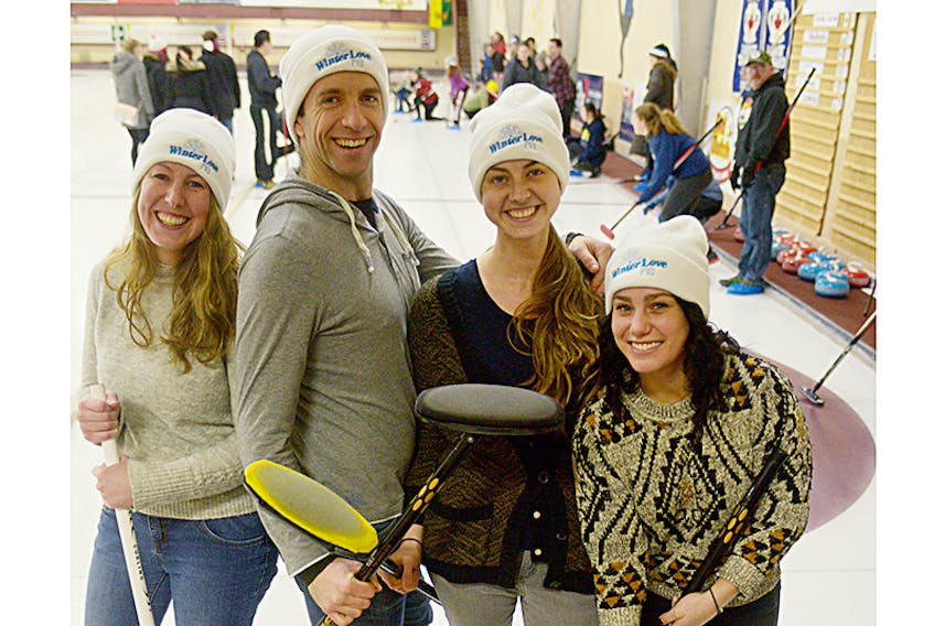 WinterLove P.E.I. event co-ordinator Stephanie Palmer, left, festival founder Mathieu Arsenault, partner co-ordinator Samantha Palmer and social media co-ordinator Jill Edwards get ready to throw some rocks during the curling and soup party held at Charlottetown Curling Complex on Sunday. The event was the first of five signature events being held as part of the third annual WinterLove P.E.I. Festival this month.  ©THE GUARDIAN
