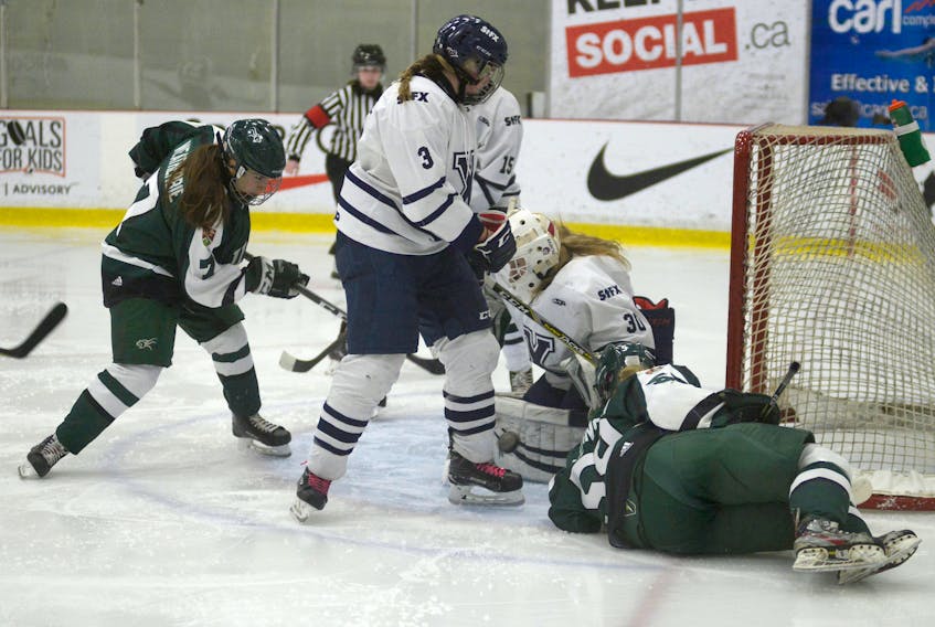 UPEI Panthers forward Emma Weatherbie, left, is stopped by the left pad of St. FX goalie Cassidy McEwan during second period action Saturday at MacLauchlan Arena.