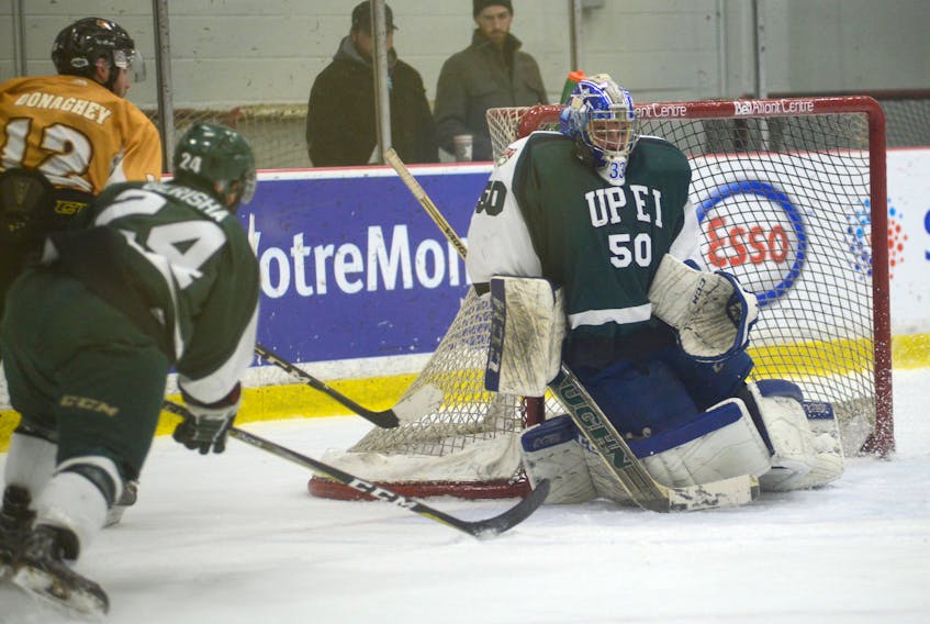 UPEI Panthers rookie goalie Matthew Mancina uses his mask to make a save Saturday against Dalhousie at MacLauchlan Arena.