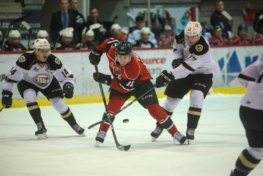 Charlottetown Islanders right-winger Liam Peyton, right, ties up Halifax Mooseheads right-winger Filip Zadina’s stick during first period action Tuesday at the Eastlink Centre in Charlottetown.