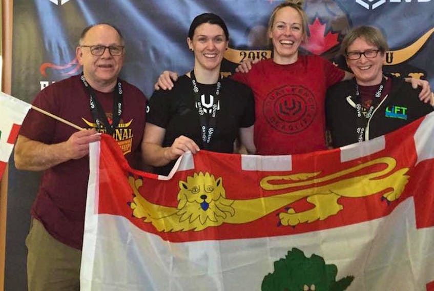 P.E.I. powerlifters, from left, Tilman Gallant, Miranda Crane, Jeri Munro and Arlene Van Diepen hold the P.E.I. flag after competing at the recent Canadian Powerlifting Union’s powerlifting and bench press championships in Calgary, Alta.