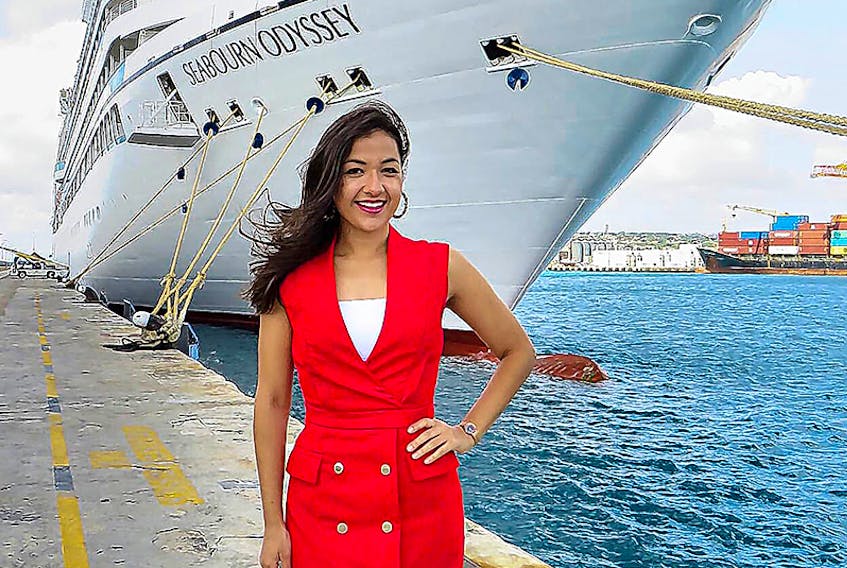 Karine Ste-Marie stands in front of her ship, the MV Seabourne Odyssey, during a stop in Barbados. The Quebec-born singer-songwriter's song, "Charlottetown" hit No. 1 on Ici Musique, Sirius XM Franco, during the week of Feb. 7-13. Ste-Marie is a production cast singer on Holland America Line. She works for Belinda King Creative Productions.  ©THE GUARDIAN