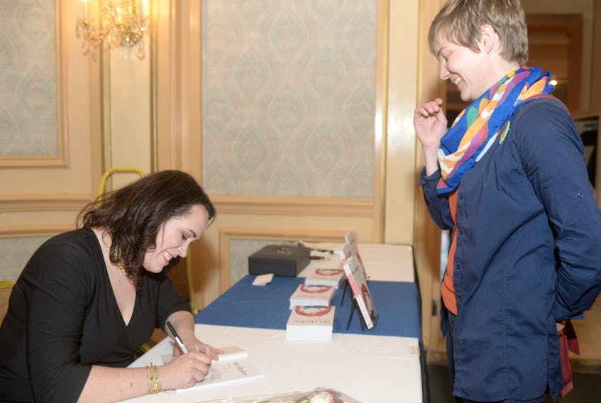Journalist Kate McKenna signs a copy of her first book, “No Choice: The 30-Year Fight for Abortion on Prince Edward Island”, for Morgan Palmer during the launch at the Rodd Charlottetown Hotel Sunday night. Palmer, who has been friends with McKenna since Grade 2, said “I’m just really proud of her.”