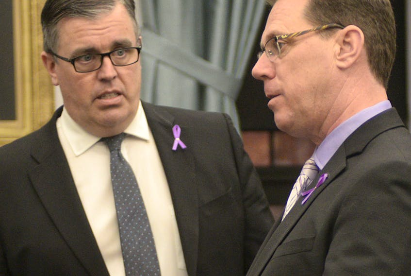 MLA Steven Myers, left, shown in the legislature with Opposition Leader James Aylward, raised concerns Thursday evening about the new Whistleblower Act.