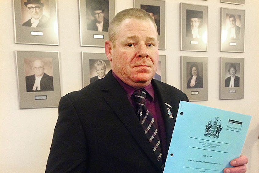 CUPE local president Jason Woodbury holds a copy of legislation that will see PTSD covered under the Workers Compensation Act. Woodbury has spent at least four years trying to bring about this change to P.E.I.  ©THE GUARDIAN