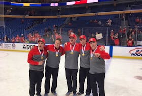 Kevin Elliott celebrates with Team Canada staff members after winning gold at the world junior hockey championship Friday in Buffalo, N.Y. From left are Brian St. Louis, Adam Douglas, Brian Cheeseman, Elliott and Chris MacDonald. Elliott will have a chance to see St. Louis tonight when his Baie-Comeau Drakkar visit the Eastlink Centre for a 7 p.m. contest with the Charlottetown Islanders.