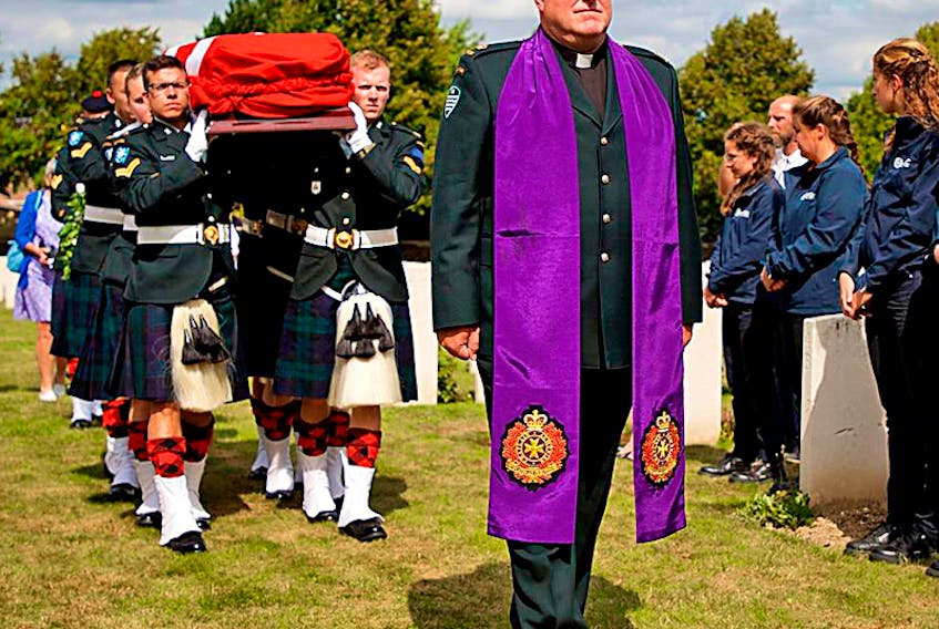 Rev. Major Tom Hamilton leads a procession in August for the funerals of St. Wilfred Shaughnessy and Private Reginald Johnston. The funerals took place in France this past August after excavation uncovered the bones of four Canadian soldiers who died in the First World War.  ©THE GUARDIAN/Submitted