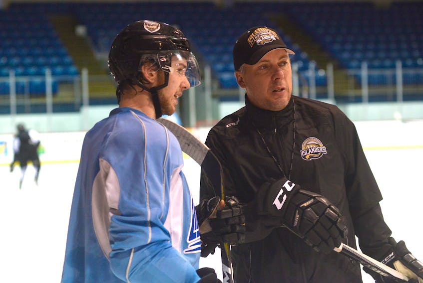 Charlottetown Islanders head coach Jim Hulton speaks with assistant captain Keith Getson at the end of Wednesday’s practice.