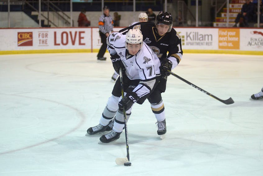 Gatineau Olympiques winger Samuel Hatto, left, tries to get the puck out of his own zone as Charlottetown Islanders forward Matthew Grouchy applies the pressure Saturday at the Eastlink Centre.