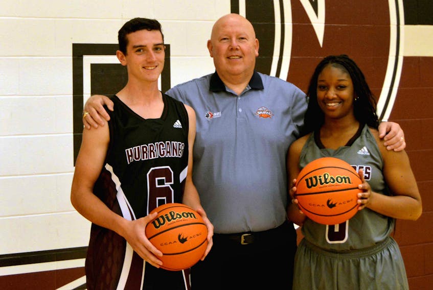Holland College Hurricanes men’s basketball player Isaac Cheverie, left, Island Storm head coach Tim Kendrick, centre, and Hurricanes women’s player Tyleigha Nelson get ready for Basketball Day in P.E.I. on Saturday, Feb. 3, when all three teams will be in action at the Eastlink Centre.