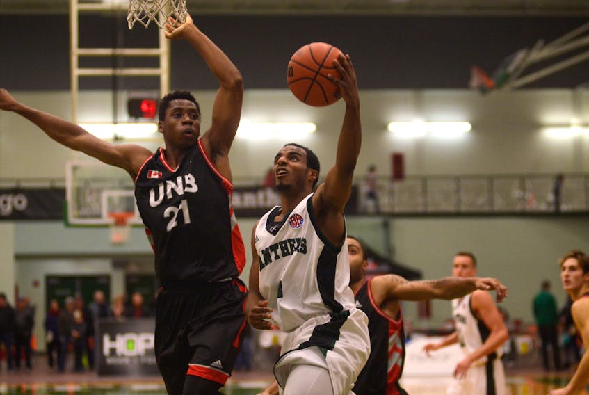 UPEI Panthers guard Samy Mohamed, right, drives to the basket while UNB Varsity Reds forward Ibrahima Doumbouya goes for the block Friday in Charlottetown. Jason Malloy/The Guardian