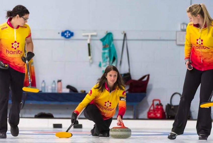 Skip Suzanne Birt, centre, delivers a rock during a match at the recent Stu Sells Oakville Tankard in Oakville, Ont., while lead Michelle McQuaid and second Meaghan Hughes prepare to sweep. Birt lost 8-1 to Kerri Einarson of Winnipeg, Man., in the semifinals. The Charlottetown-based rink also includes third Marie Christianson.