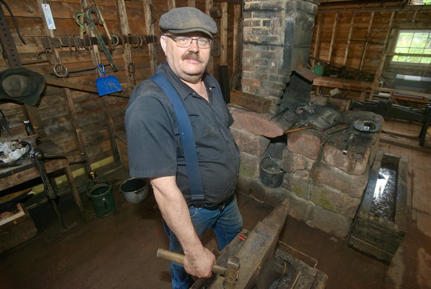 Bruce Brown stands in front of the blacksmith forge at Orwell Corner Historic Village. Brown left the IT industry about eight years ago and shortly after began working at the village, where he eventually found a new passion for blacksmithing.