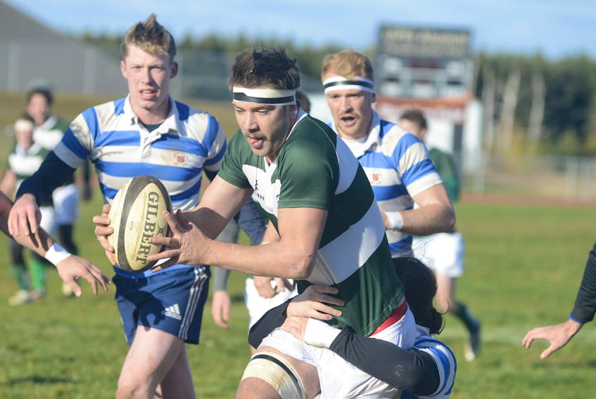 Liam Carter, of the UPEI Panthers, drags a St. FX X-Men Saturday during the first half of the Maritime university rugby championship. Jason Malloy/The Guardian
