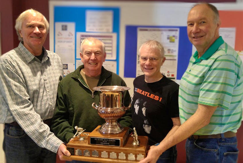 From left to right, lead stone David Murphy, skip Bill Hope, third Craig Mackie and second Peter Murdoch display their trophy after winning the  P.E.I. senior men’s curling championship Monday in Crapaud.