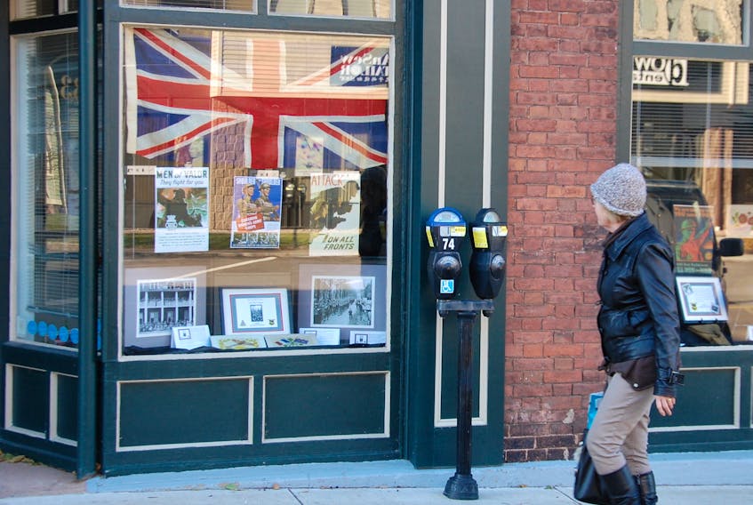 A woman takes in the window display depicting Charlottetown and its citizens during wartime. The exhibit, entitled Lest We Forget, is being displayed in the windows of the Planning and Heritage Department at 233 Queen Street until Dec. 1, 2017.