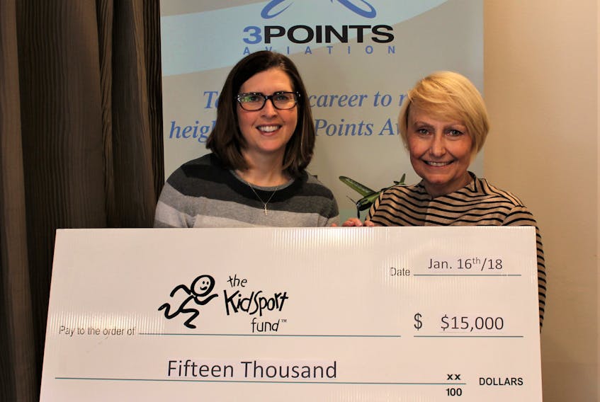 3 Points Aviation’s Dianne Griffin, right, presents a $15,000 cheque to Sport P.E.I. executive director Gemma Koughan for the KidSport program.