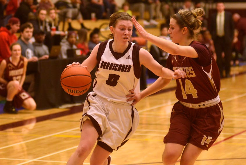 Holland College Hurricanes guard Lexi MacInnis, right, drives on Mount Allison Mounties guard Karly Buckingham during collegiate women’s basketball action Thursday in Charlottetown.