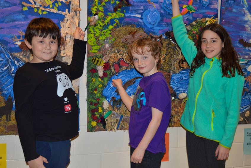 Students at West Royalty Elementary School in Charlottetown were creating some impressive art on Thursday. These Grade 4 students show off what they helped with. From left, are Alexander MacDonald, Carson McBride and Kelsi MacKinnon.