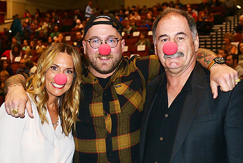 Organizer Kate Flanagan, from left, emcee Al Douglas and Reid Burke, executive director of the Canadian Mental Health Association (CMHA) in P.E.I., share a laugh before the Red Nose Talent Show held at Florence Simmons Performance Hall in Charlottetown Saturday night. The event saw 15 performances by Island youth while also raising funds for the CMHA.  ©THE GUARDIAN/Mitch MacDonald