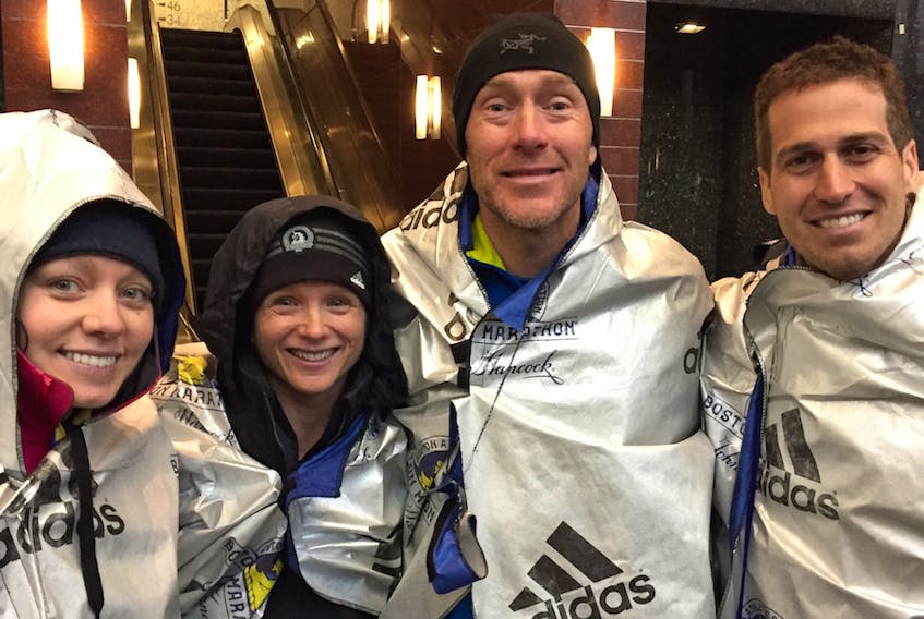 P.E.I. runners, from left, Amber Spriggs, Jocelyn Peterson, Mike Peterson and Stan Chaisson stand wrapped to warm up and happy after running the Boston Marathon on Monday in Boston, Mass. Chaisson from Charlottetown was the top Islander finishing in two hours, 44 minutes and 12 seconds.