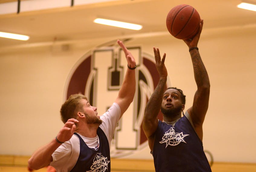 Torrence Dyck, right, takes a shot over Wayne McCullogh during Island Storm practice Tuesday at Holland College. Jason Malloy/The Guardian