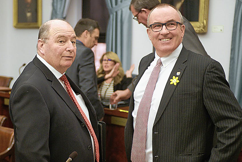 Montague-Kilmuir MLA Allen Roach, left, chats with Summerside-Wilmot MLA Chris Palmer prior to Tuesday’s question period. Roach tabled a private member’s bill Tuesday evening that aims to reduce single-use, plastic checkout bags by P.E.I. businesses.  ©THE GUARDIAN