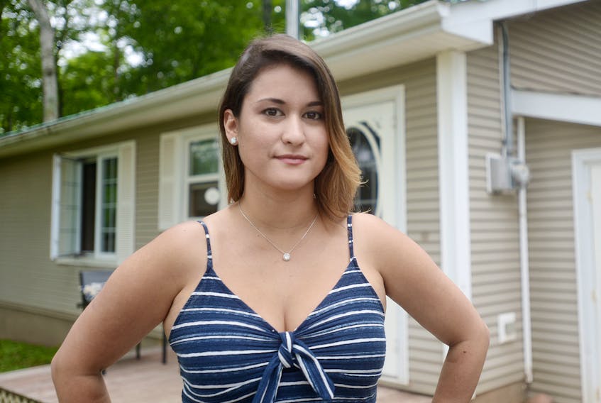 Thamara DeVries stands outside one of the homes she rents out in Hampshire. The landlord would like to see the province take steps to create more accountability for problem tenants, such as a rating system, after she said a tenant stole more than $3,500 in items from her home after being evicted.