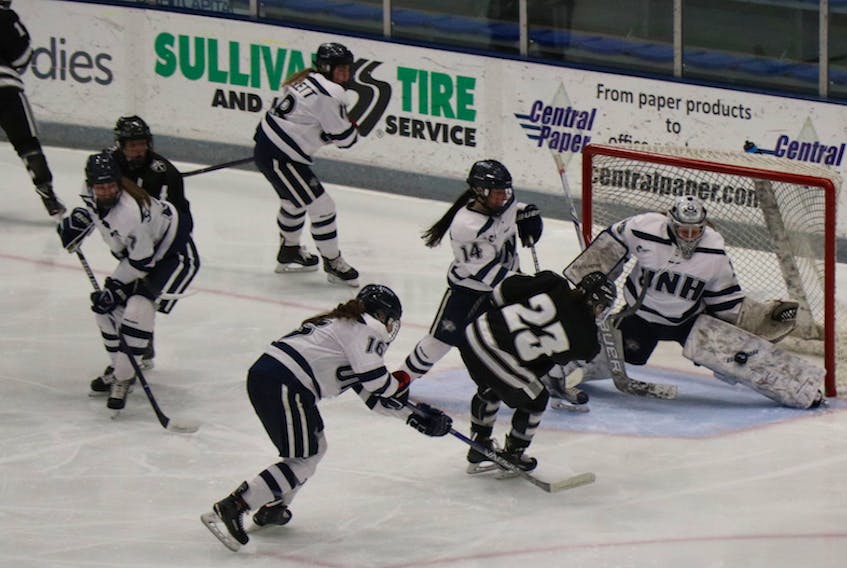 Charlottetown native Ava Boutilier of the University of New Hampshire Wildcats makes a pad save against Madison Sansone (#23) of the Providence Friars last season in a Hockey East women’s action.