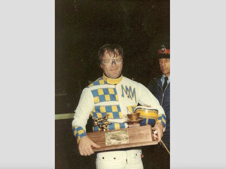 Mike MacDonald displays The Evening Patriot Gold Cup and Saucer Trophy after winning Atlantic Canada’s most prestigious harness race at the Charlottetown Driving Park. It was one of his record-setting five Gold Cup wins.
