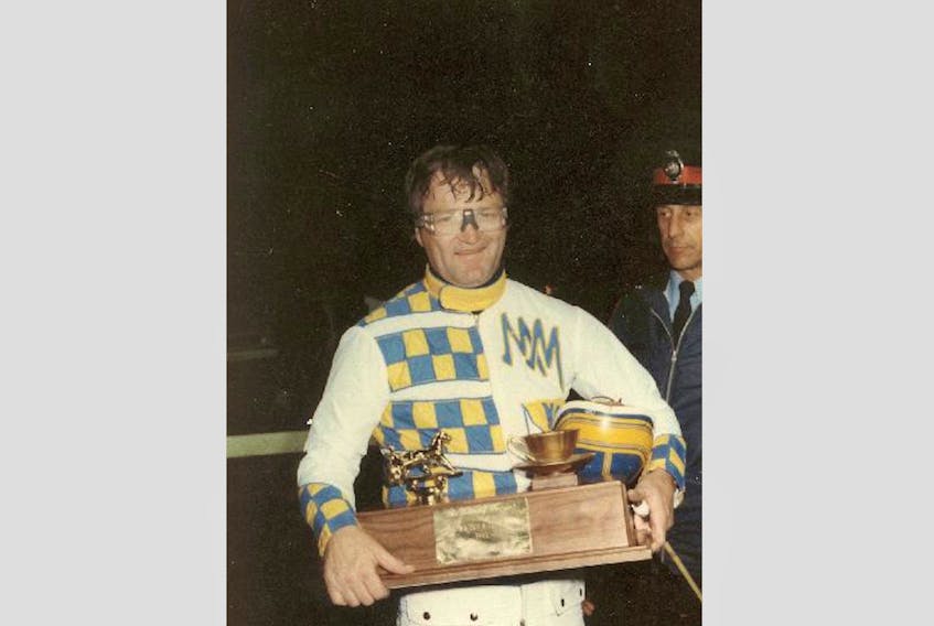 Mike MacDonald displays The Evening Patriot Gold Cup and Saucer Trophy after winning Atlantic Canada’s most prestigious harness race at the Charlottetown Driving Park. It was one of his record-setting five Gold Cup wins.