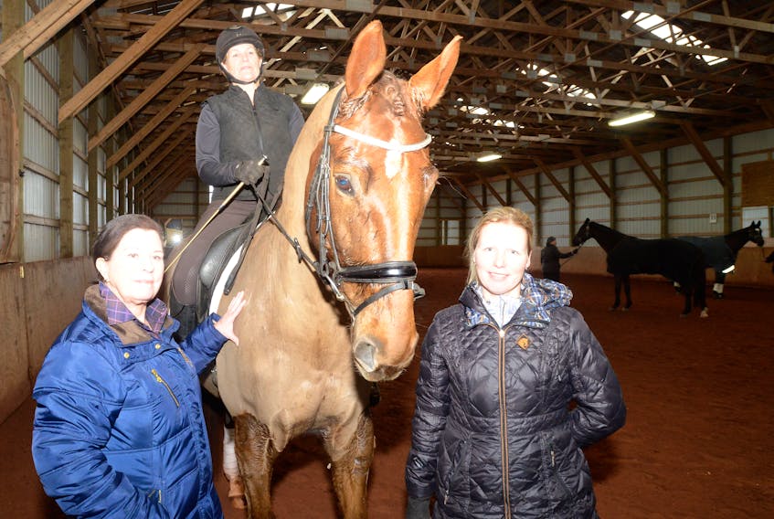 Cindy Ishoy is shown during her recent visit to Prince Edward Island for a weekend dressage clinic. From left are Ishoy, Kim Dolan on Cambridge and Harma Fraser.