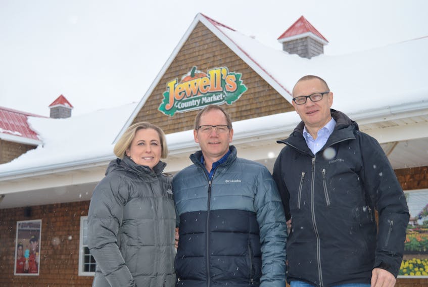 Edwin Jewell, centre, has sold Jewell’s Country Market to Chris and Zuzana Seemann, but will stay on for the next two years to help ease the transition.