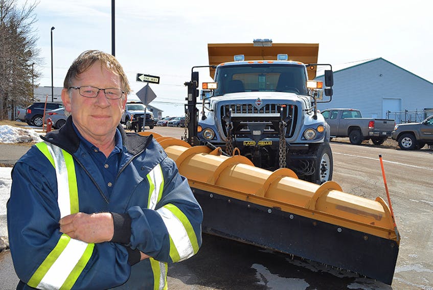 Gordon MacDougall, a truck driver with Charlottetown’s public works department, checks his vehicle on Wednesday. The city’s budget contains money for a new plow truck along with assorted other equipment.  ©THE GUARDIAN