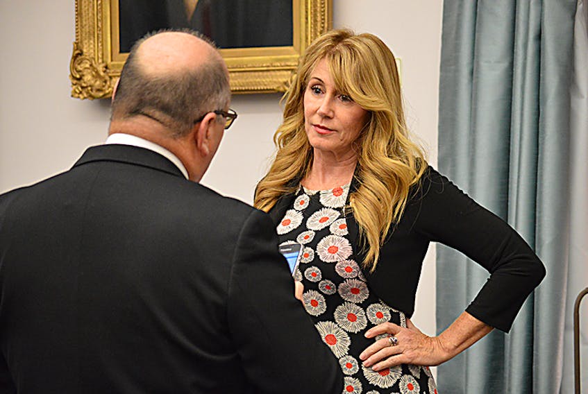 Family and Human Services Minister Tina Mundy says public consultations will be held in 2018 to help craft a poverty reduction strategy for P.E.I. She is shown in the provincial legislature with Finance Minister Allen Roach.  ©THE GUARDIAN