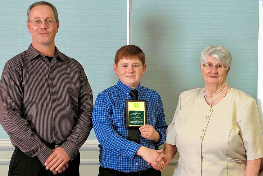 Patrick Lauwerijssen, centre, of the Albany Centennial 4-H Club was the winner of the Elmer Larsen Memorial Member Recognition Award. Presenting the award are Roma and Peter Larsen.