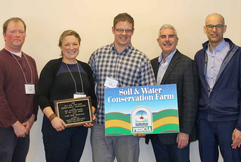 Mark Bernard, centre, and Sally Bernard of Barnyard Organics receive the soil conservationist of the year award in the cash crop category from John Hooper, left, president of the P.E.I. Soil and Crop Improvement Association, John Jamieson, deputy minister of Agriculture and Fisheries and Mark Grimmet of Agriculture and Agri-Food Canada.
